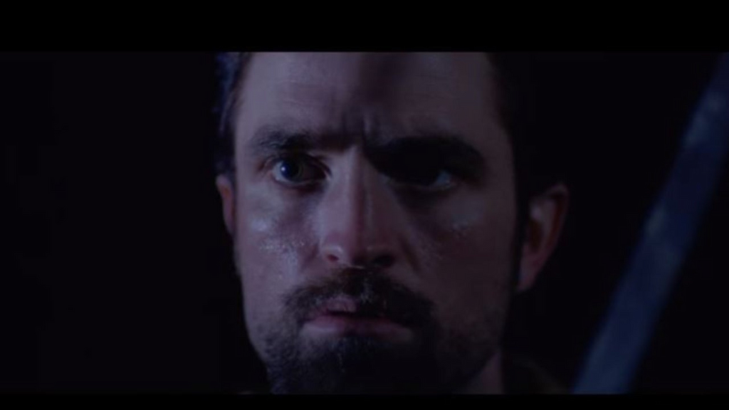 Robert Pattinson in Oneohtrix Point Never's "The Pure and the Damned" music video