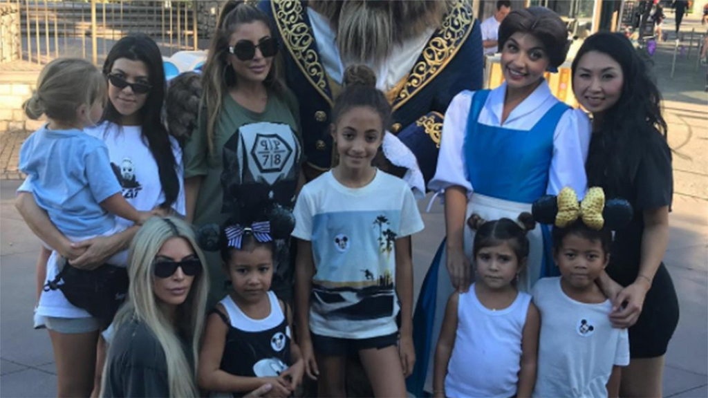 Kim and Kourtney Kardashian enjoy Disneyland with their friends