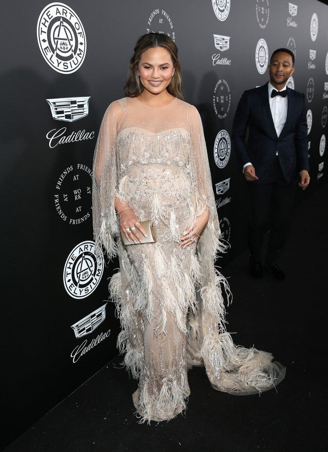 Chrissy Teigen Glows In A Stunning Silver Feather Covered Maternity Red Carpet Dress Wkyc Com