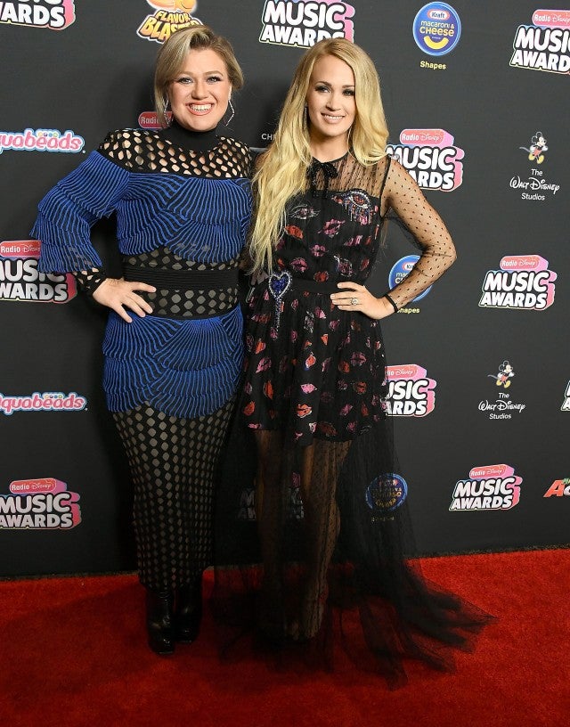 Kelly Clarkson, Carrie Underwood arrives at the 2018 Disney Music Awards at the Loews Hollywood Hotel on June 22, 2018 in Hollywood, California.