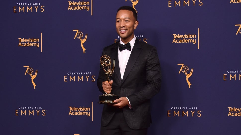 John Legend holding his Emmy trophy, which completed his EGOT journey.