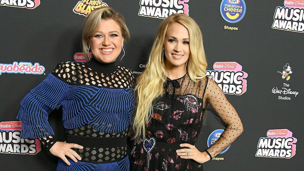 Kelly Clarkson, Carrie Underwood arrives at the 2018 Radio Disney Music Awards at Loews Hollywood Hotel on June 22, 2018 in Hollywood, California.