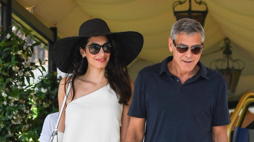 George Clooney and Amal Clooney are seen walking hand in hand as they leave their hotel to take an helicopter ride exploring Venice, Italy. 