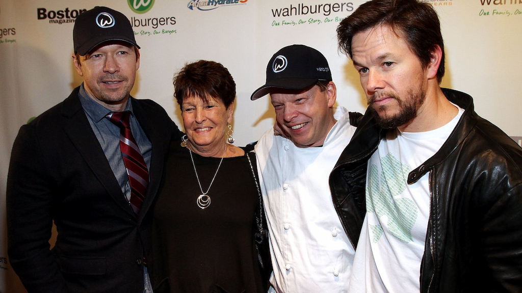 Donnie Wahlberg, their mother Alma Elaine Wahlberg, chef Paul Wahlberg and Mark Wahlberg attend the grand opening of Wahlburgers on October 24, 2011 at the Hingham Shipyard in Boston, Massachusetts.
