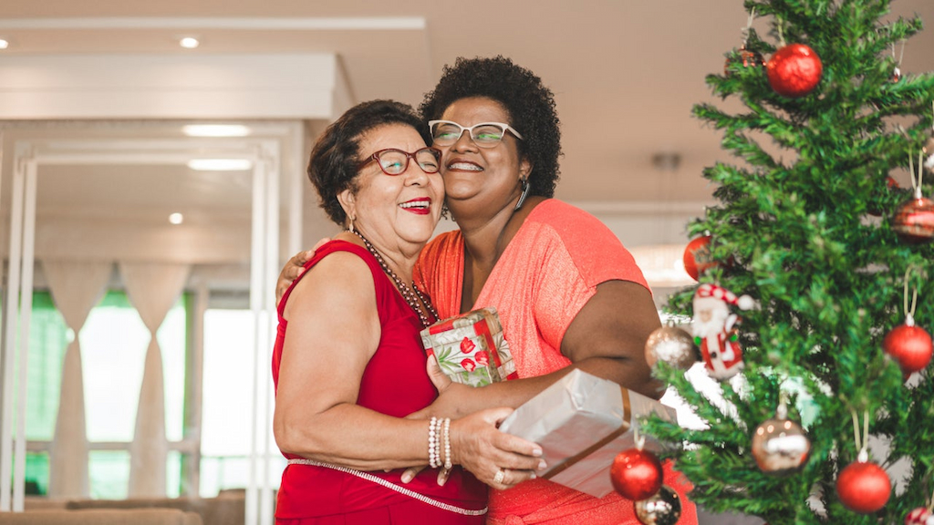 Mom and daughter hug while exchanging gifts