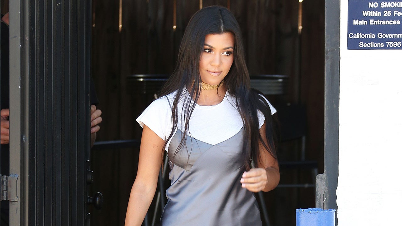 kourtney kardashian shirt dress Kourtney Kardashian shows off tanned and toned legs beneath unique  over-sized shirt turned minidress