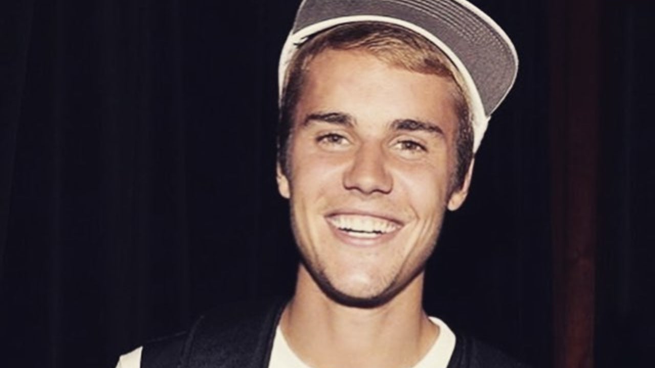 Justin Bieber shirtless showing his chest and torso tattoos, including his large Son Of God script