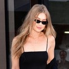 Gigi Hadid in black outfit and snakeskin belt