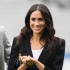 Meghan Markle in black pantsuit with Prince Harry on soccer field