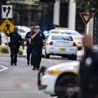 Police gather after an active shooter was reported at the Jacksonville Landing in Jacksonville, Fla., Sunday, Aug. 26, 2018. A gunman opened fire Sunday during an online video game tournament that was being livestreamed from a Florida mall, killing multiple people and sending many others to hospitals.
