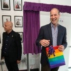 Prince William, Duke of Cambridge, reacts to receiving a gift bag from trust chief executive officer Tim Sigsworth during a visit to the Albert Kennedy Trust in London to learn about the issue of LGBTQ youth homelessness in London on June 26, 2019.