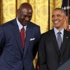 U.S. President Barack Obama smiles up at National Basketball Association Hall of Fame member and legendary athlete Michael Jordan before awarding him with the Presidential Medal of Freedom 