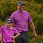 Tiger Woods smiles while standing with his son Charlie Woods on the 16th green during the first round of the PGA TOUR Champions PNC Championship at Ritz-Carlton Golf Club on December 19, 2020 in Orlando, Florida.