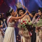 In this photograph taken on April 4, 2021, winner of Mrs. Sri Lanka 2020 Caroline Jurie (2-L) removes the crown of 2021 winner Pushpika de Silva (C) as she is disqualified by the jurie over the accusation of being divorced, at a beauty pageant for married women in Colombo.