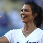 Kourtney Kardashian looks to give a high-fiven after throwing out the ceremonial first pitch prior to the MLB game at Dodger Stadium on August 2, 2018 in Los Angeles, California. The Dodgers defeated the Brewers 21-5.