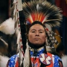 Nathan Chasing Horse of Rosebud, South Dakota, and a member of the Sioux Tribe, leads the Color guard at the beginning of the grand entry into the coliseum