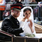 Prince Harry, Duke of Sussex and Meghan, Duchess of Sussex wave from the Ascot Landau Carriage during their carriage procession on Castle Hill outside Windsor Castle in Windsor, on May 19, 2018 after their wedding ceremony.