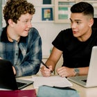 Teens doing homework on laptops