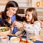 girl opening Hanukkah gift