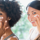 Women applying moisturizer
