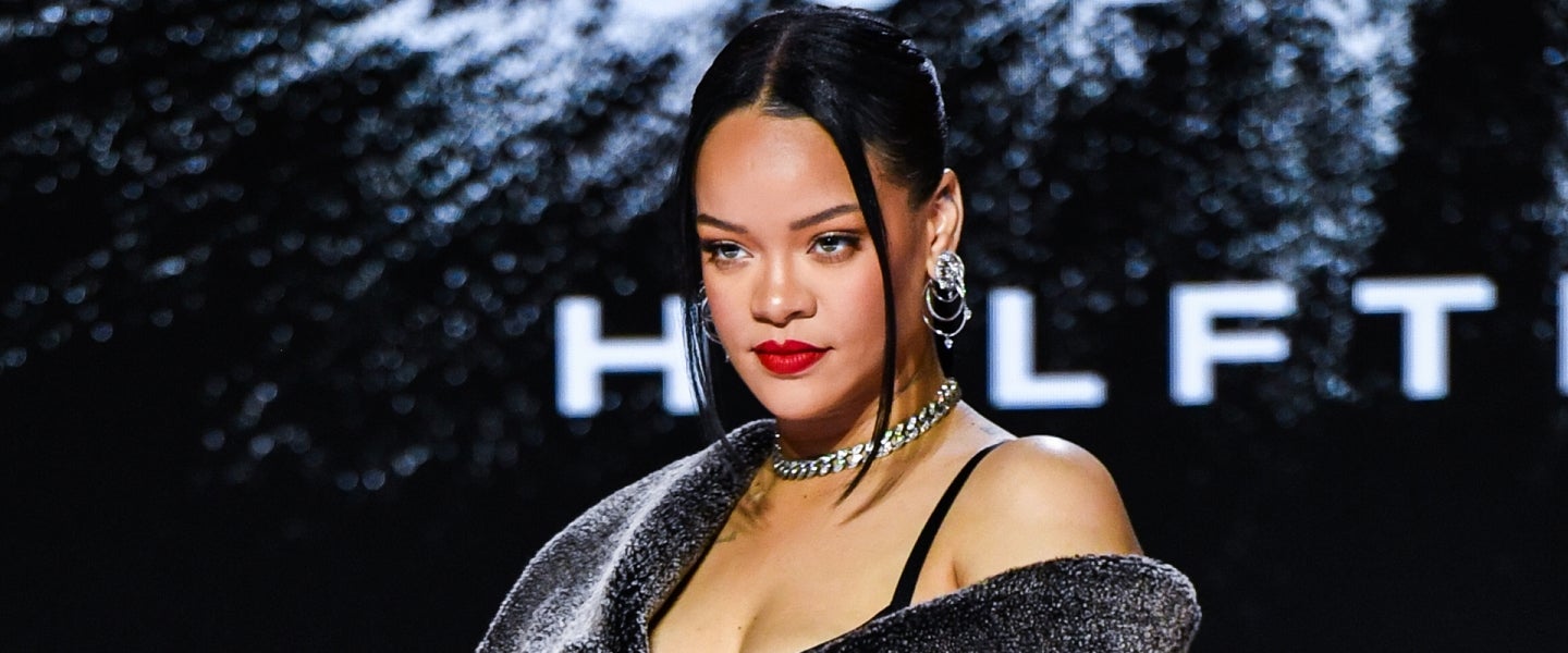 Rihanna makes jaws drop posing up in sexy low-cut dress during PFW