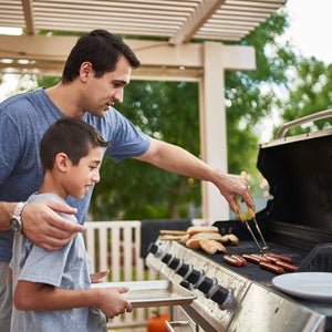 Dad and son grilling