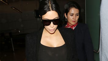 Kim Kardashian Shows Off Growing Baby Bump in Sheer Catsuit