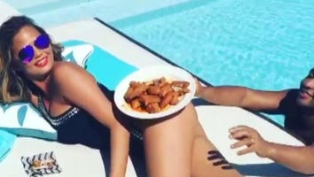Watch Chrissy Teigen Balance a Plate of Chicken Wings on Her Butt