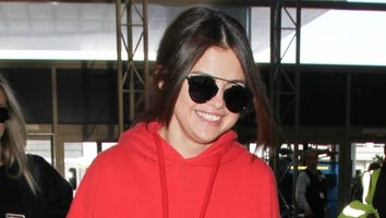Selena Gomez Rocks a Red Sweat Suit and Heels on Her Way to Paris Fashion Week, Because Why Not?