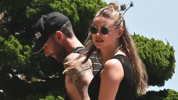 Behati Prinsloo Bares Her Baby Bump By the Pool, Jokes 'Belly Button Still on Point'
