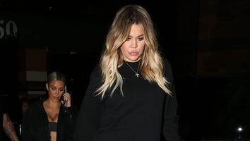 Khloe Kardashian Covers Up Stomach in Loose-Fitting Shirt, Pairs With Sky-High Boots and Skinny Jeans
