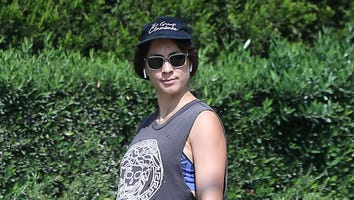 Troian Bellisario Casually Debuts Baby Bump While Walking Her Dogs