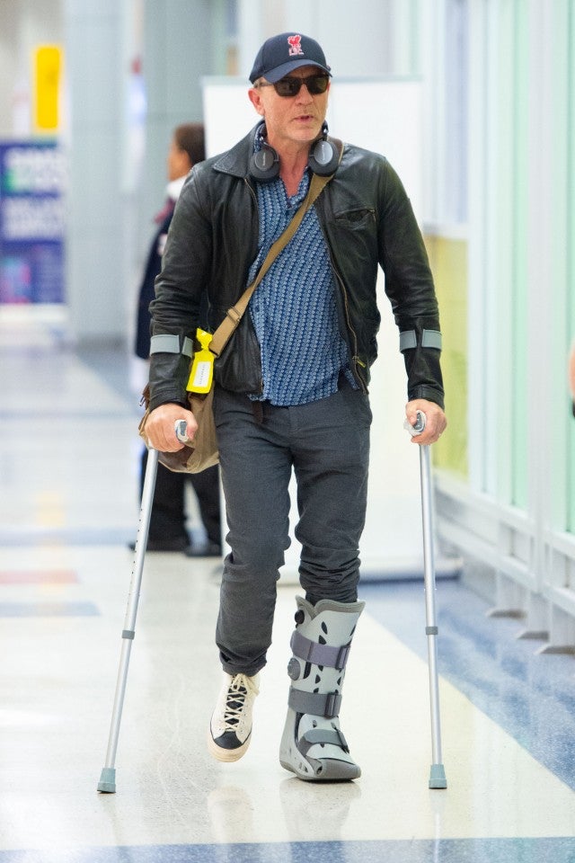 Daniel Craig on Crutches and Wearing a Boot in Airport After Suffering