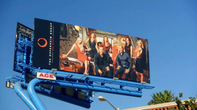 The cast of 'Selling Sunset' on a billboard for The Oppenheim Group.