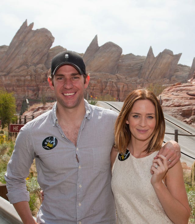 John Krasinski and Emily Blunt pose at the Cars Land attraction at disneyland