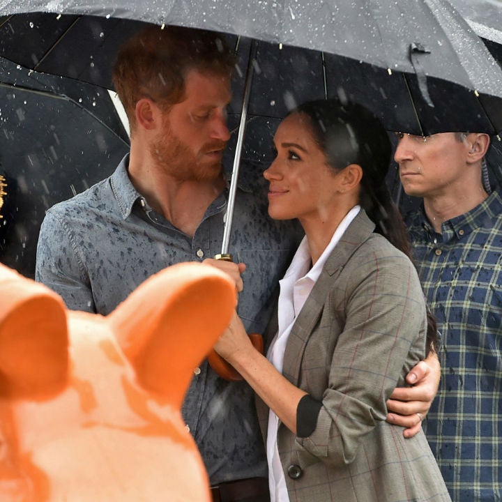 These Pics of Meghan Markle and Prince Harry Cuddling in the Rain Prove True Love Exists