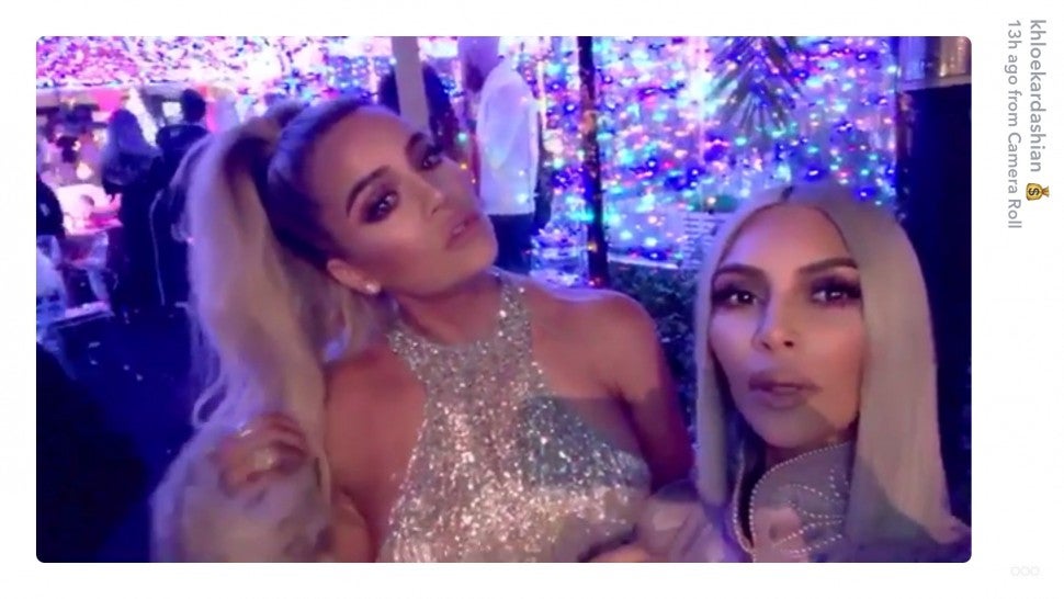 Khloe Kardashian and Kim Kardashian at xmas eve party