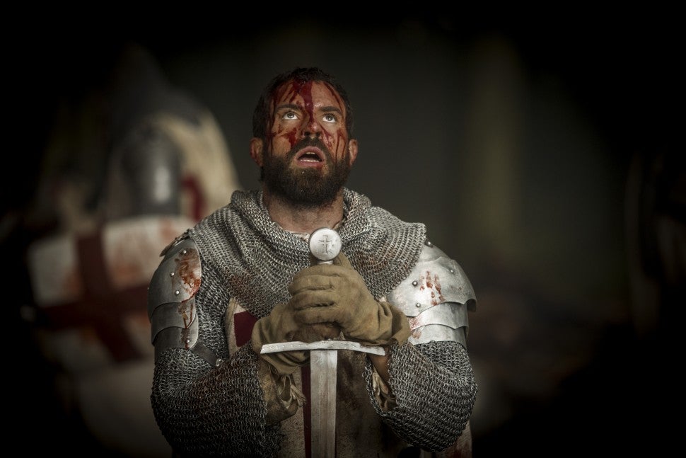 tom_cullen_as_landry_bowed_before_his_sword_in_historys_new_drama_series_knightfall_r_gold_1