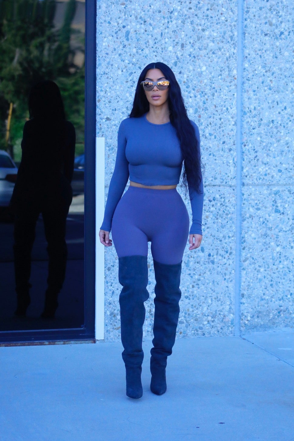 Kim Kardashian in gray spandex outfit