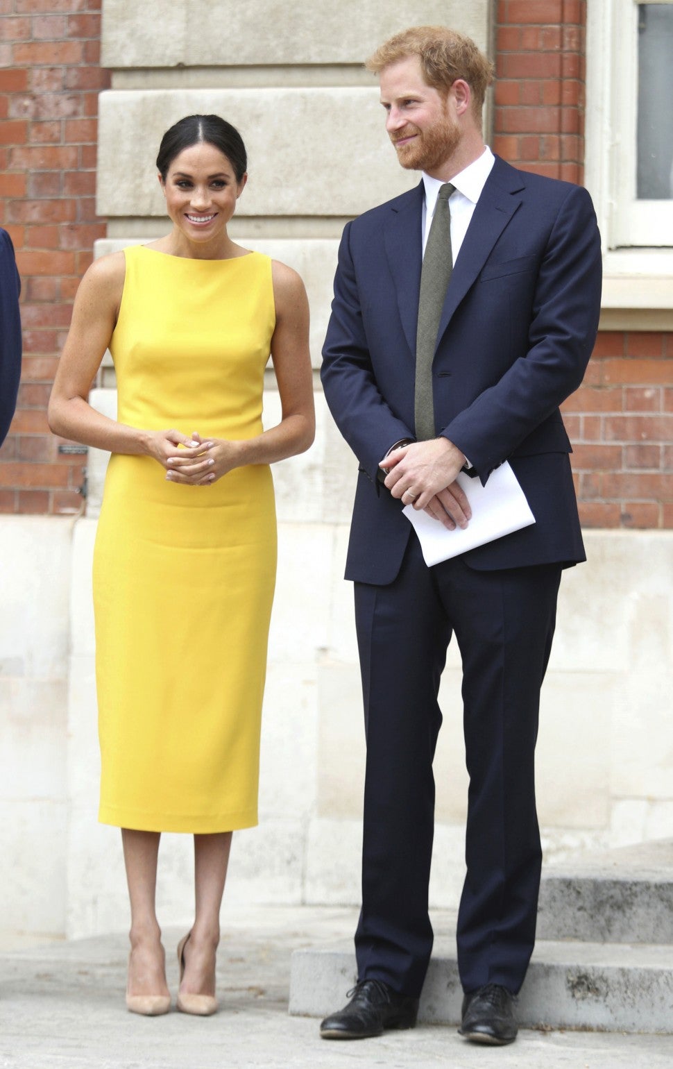 Meghan Markle in yellow dress with Prince Harry