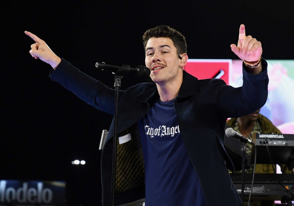 Nick Jonas performs at a chairty concert on the field at Angel Stadium