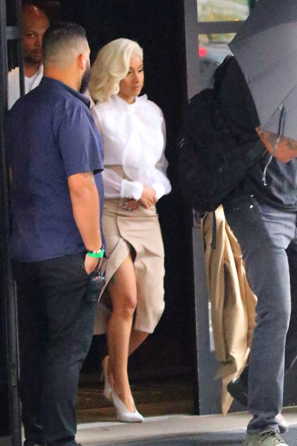 Cardi B looks stylish, in a thigh-high slit skirt and white blouse, as she leaves her hotel on her way to turn herself in to police in New York City, NY, in connection to a fight at a Queens strip club.