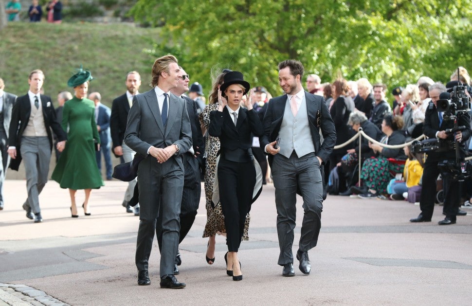 Cara Delevigne Holds Onto Hat at Royal Wedding