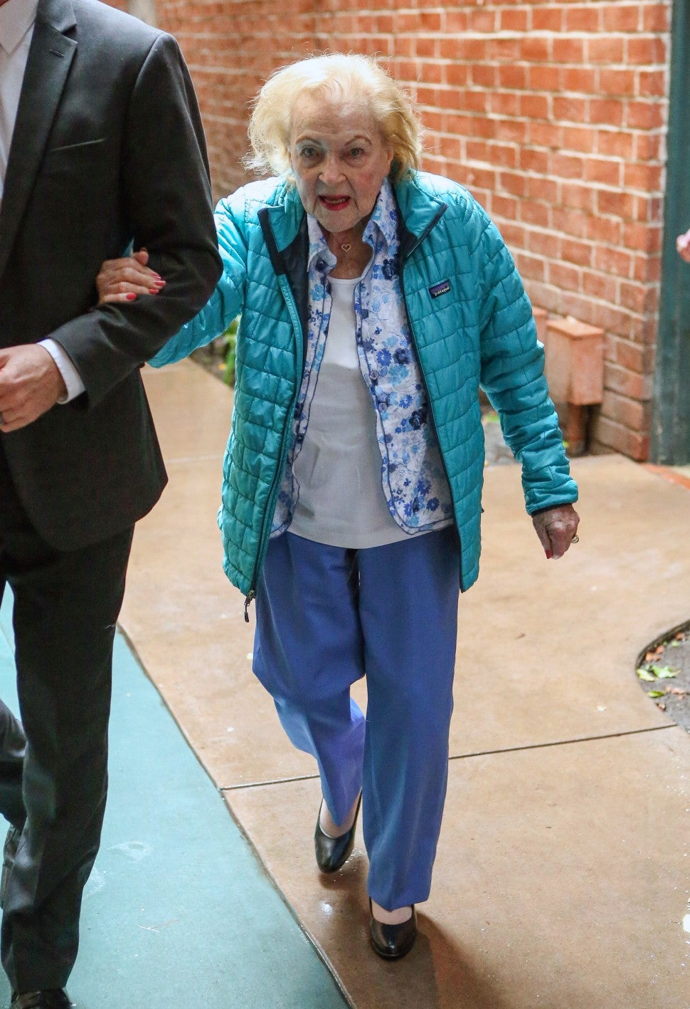 A beaming Betty White looks happy and healthy as she runs errands the day before her 97th birthday. 