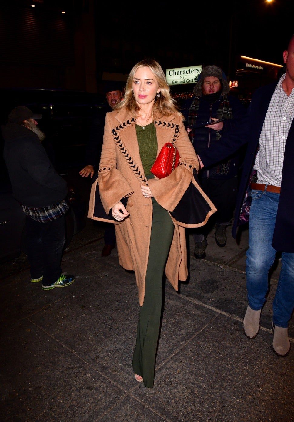 Emily Blunt in camel coat and olive green outfit