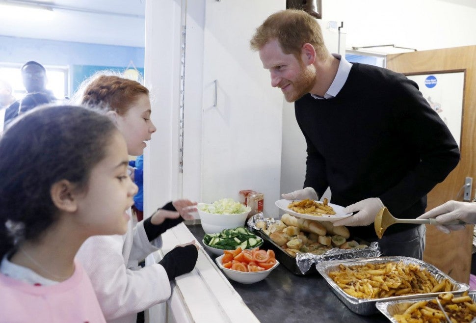 Prince Harry serves healthy food to children in London