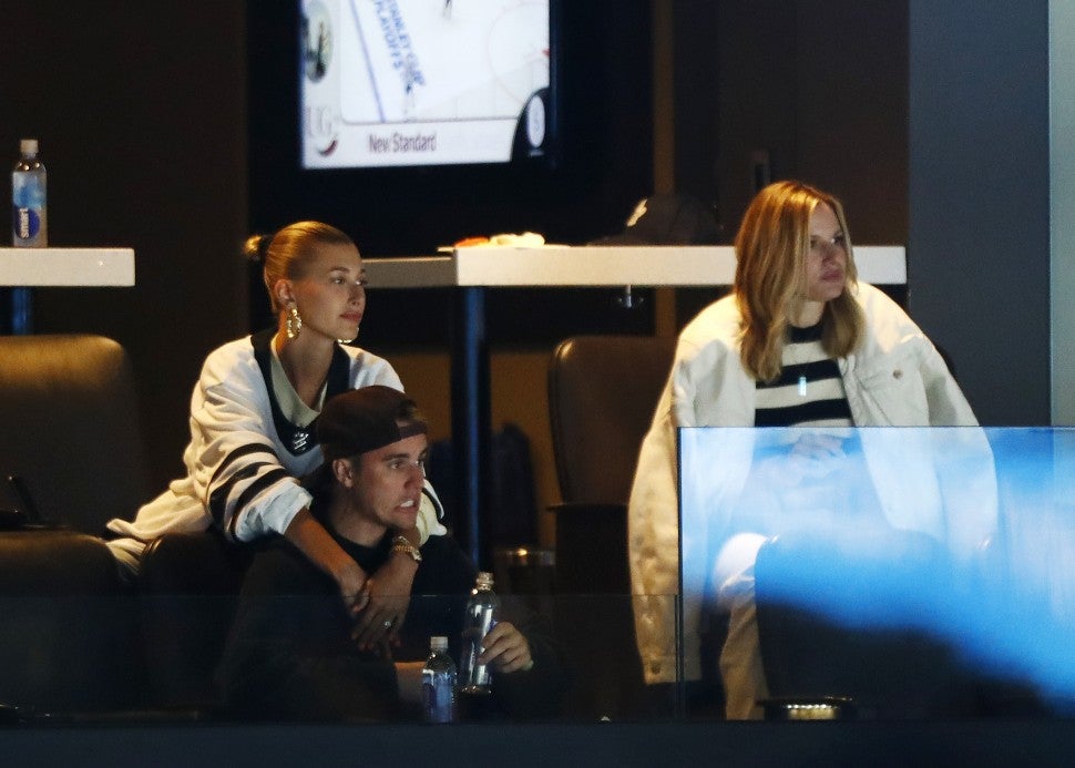 Justin Bieber reacts and wife Hailey Rhode Bieber looks on during Game Seven of the Eastern Conference First Round during the 2019 NHL Stanley Cup Playoffs between the Boston Bruins and the Toronto Maple Leafs at TD Garden on April 23, 2019 in Boston, Massachusetts.