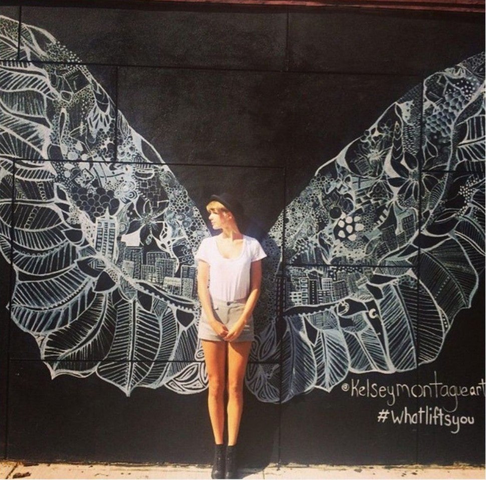Taylor Swift in front of angel wings