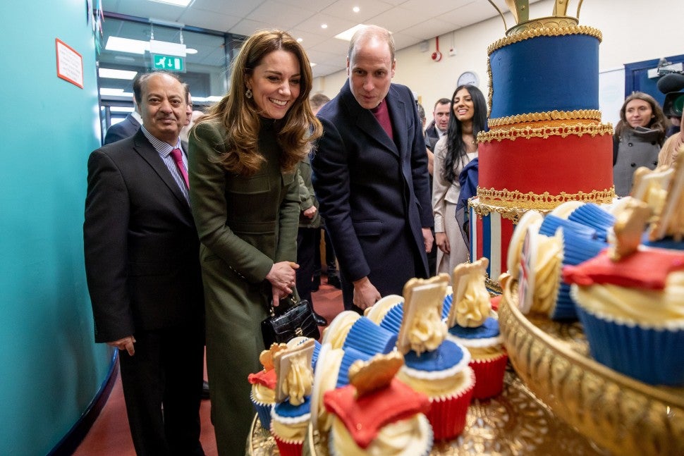 Prince William, Duke of Cambridge and Catherine, Duchess of Cambridge inspect cakes as they visit the Khidmat Centre on January 15, 2020 in Bradford, United Kingdom. 