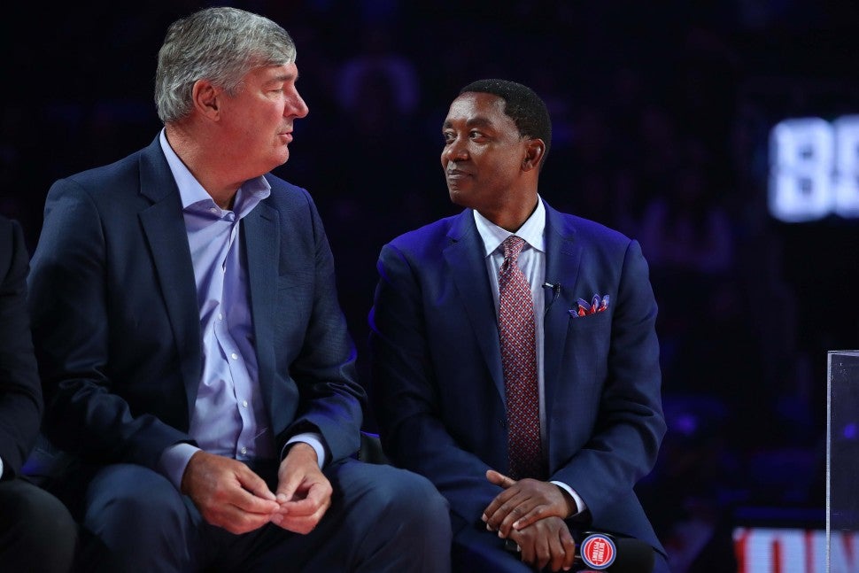 Former Detroit Piston Isiah Thomas talks to teammate Bill Laimbeer during a celebration of the 1989 and 1990 World Championship Detroit Pistons at halftime during a game between the Portland Trail Blazers and Detroit Pistons at Little Caesars Arena on March 30, 2019 in Detroit, Michigan
